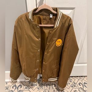 Oversized smiley face varsity jacket